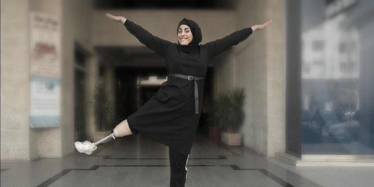 Eman Al-Shayyab smiling while standing on one leg with her arms raised in front of Polus' and ADT's rehabilitation center in Amman, Jordan. Her raised leg is a prosthetic provided to her by Polus and ADT. Photo credit: Stephen Petegorsky