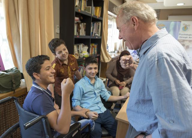 Polus Center International's Executive Director, Michael Lundquist, with children at the ADT Rehabilitation Centre in Amman.