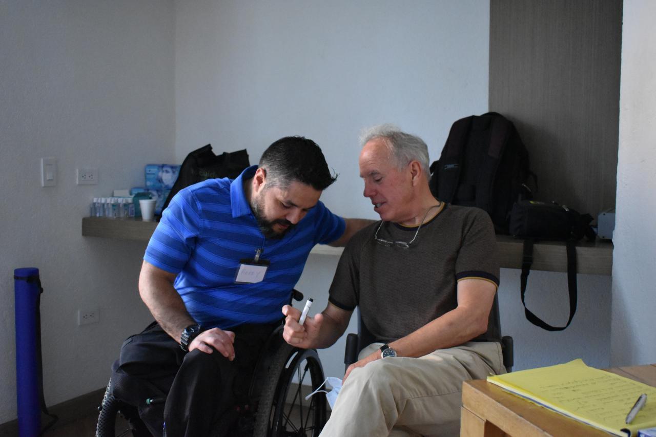 Two men sitting and talking.