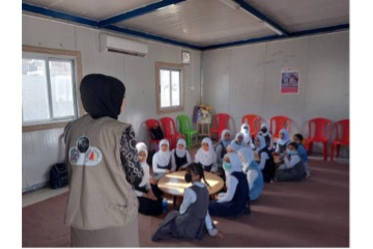 Teacher in front of classroom of young girls in Mosul Iraq